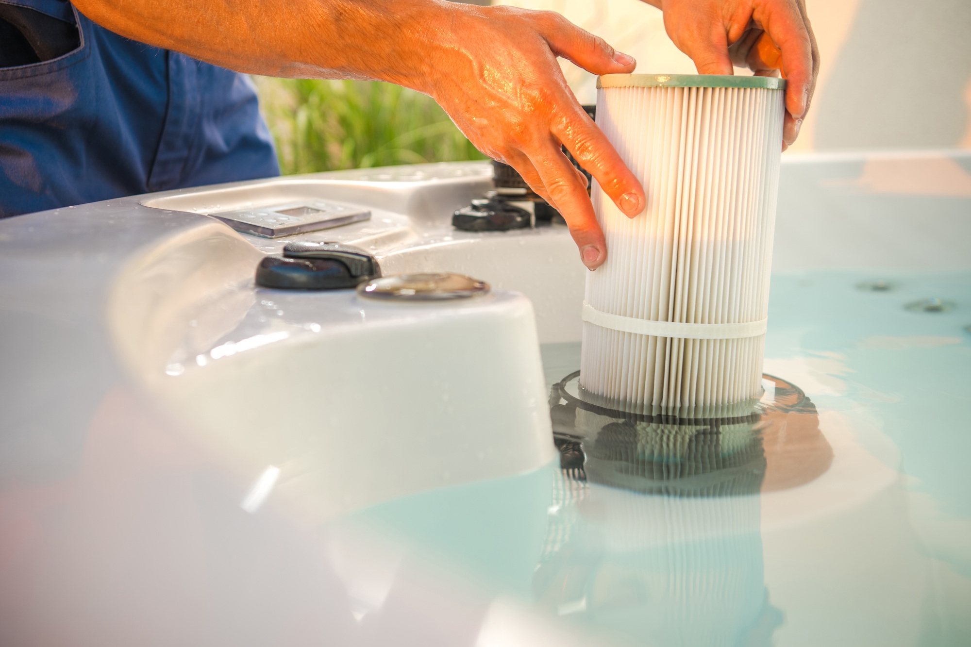 Hot Tub Technician Removing Water Filter and Performing Scheduled Garden SPA Maintenance