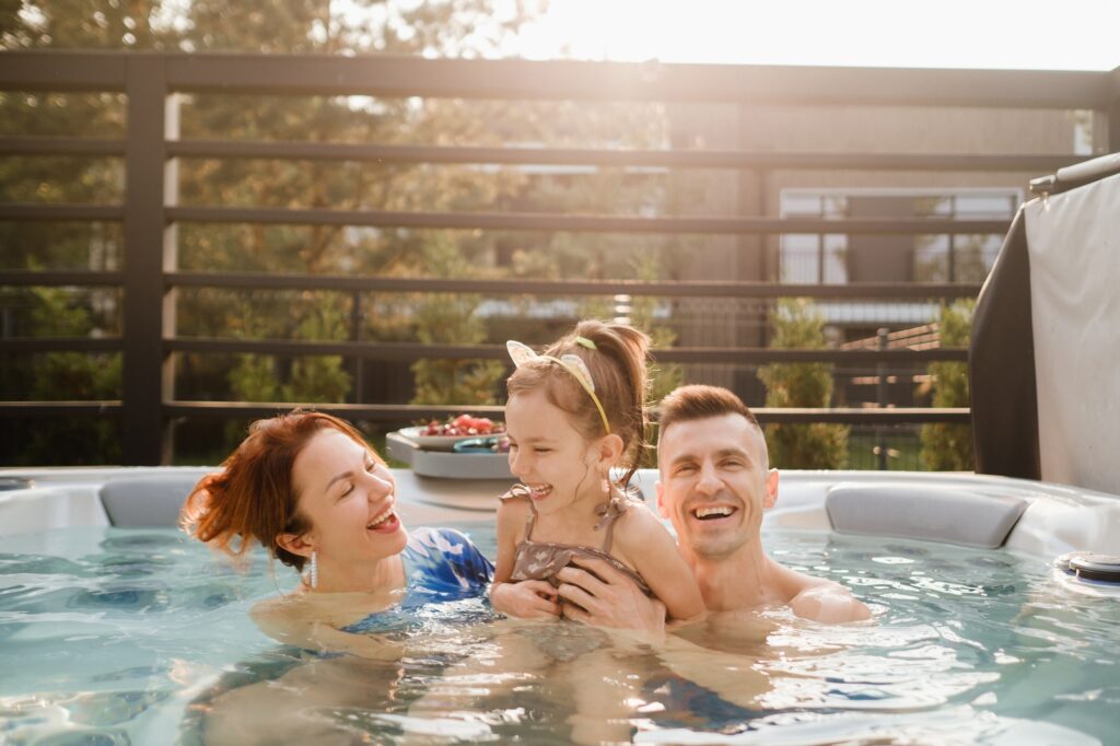 In summer, the family rests in the outdoor hot tub