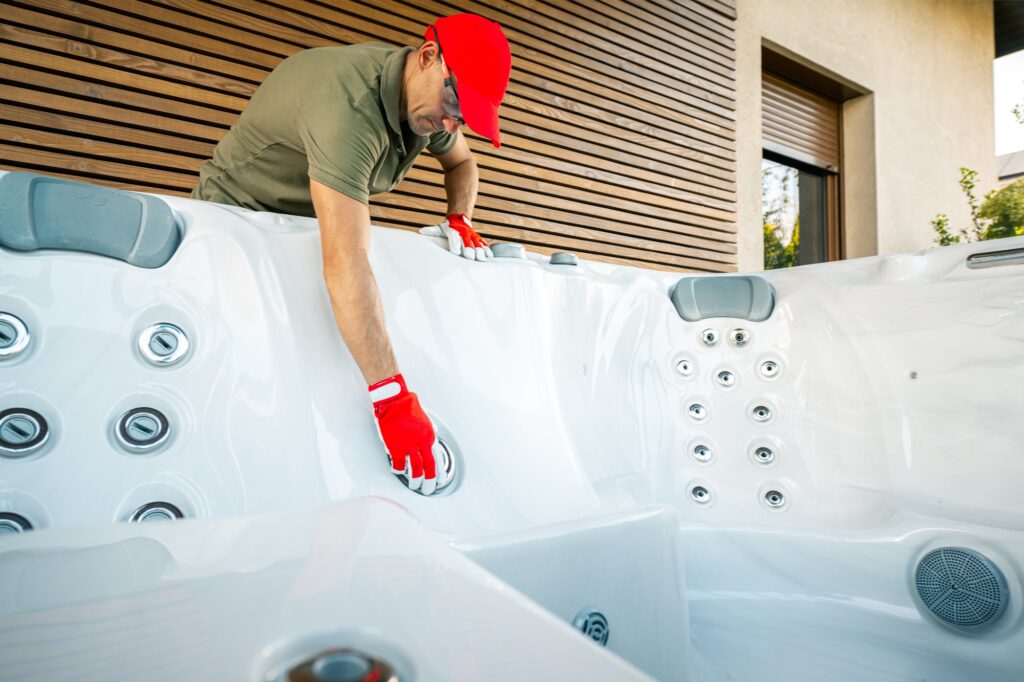 Technician Performing Maintenance on a Hot Tub in a Modern Outdoor Patio Setting at Midday