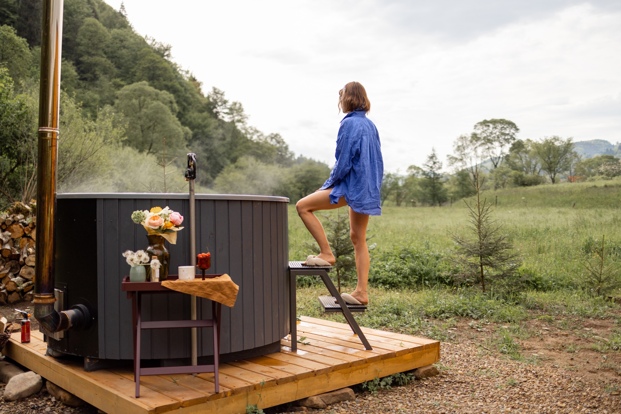 Woman rests in house with hot tub in the mountains